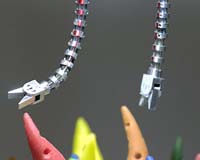 The snakelike robot designed by Johns Hopkins engineers features two thin rods tipped with tentaclelike tools capable of moving with 6 degrees of freedom.